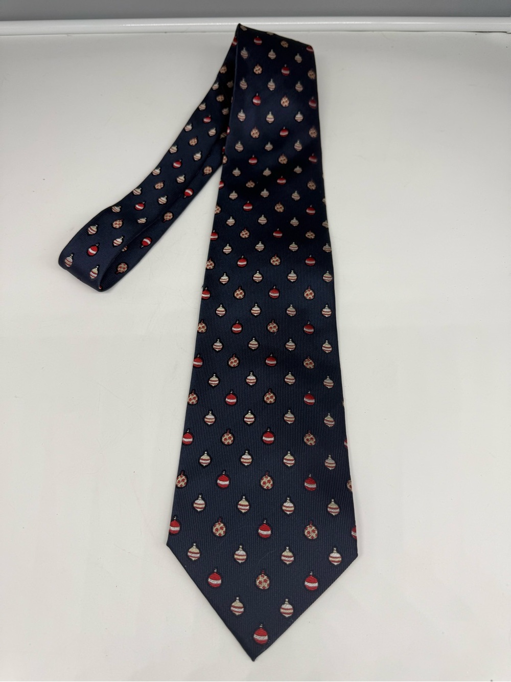 Silk Van Heusen men's necktie, featuring pattern of colorful Christmas ornaments